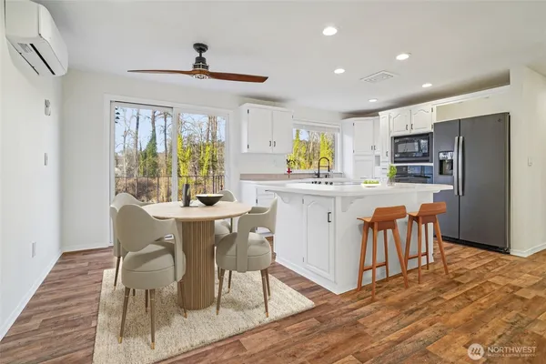a dining room with furniture a window and wooden floor