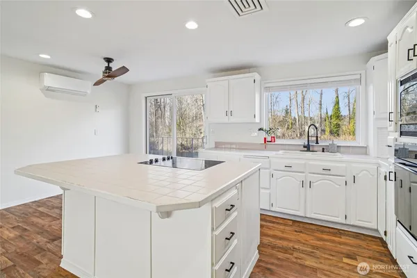 a kitchen with sink cabinets and wooden floor
