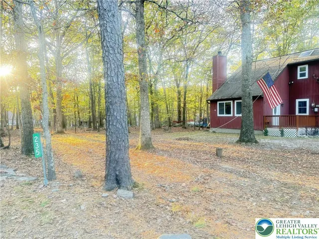 a pathway to a house with a yard