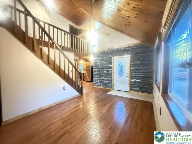 a view of an entryway with wooden floor