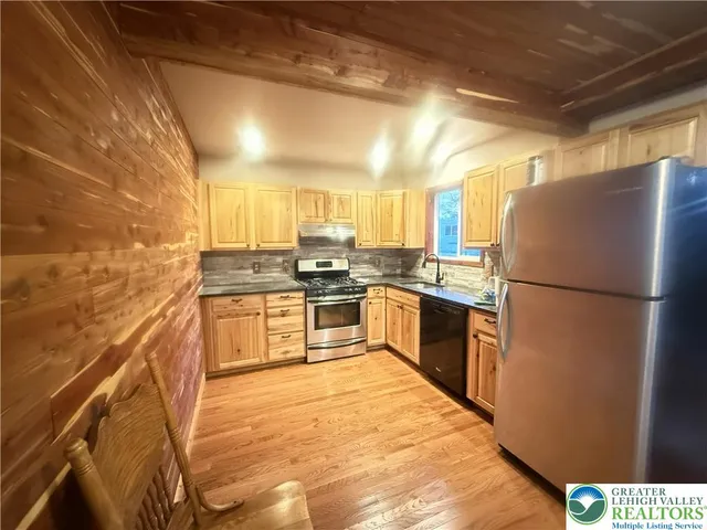 a kitchen with a refrigerator a sink and a stove