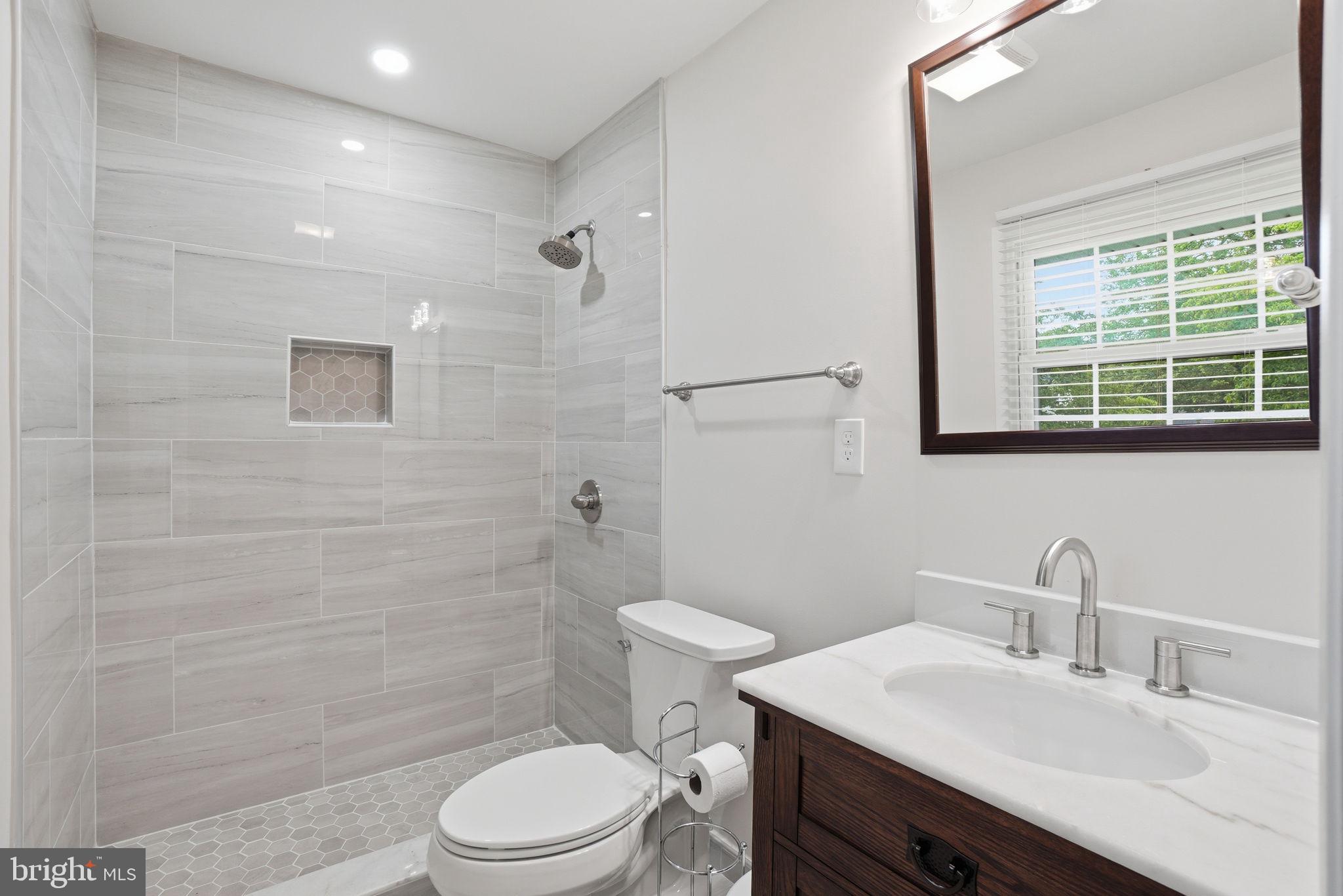 5304 Pillow Lane Springfield, VA 22151 - Photo 19 of 32 a bathroom with a sink a toilet and shower