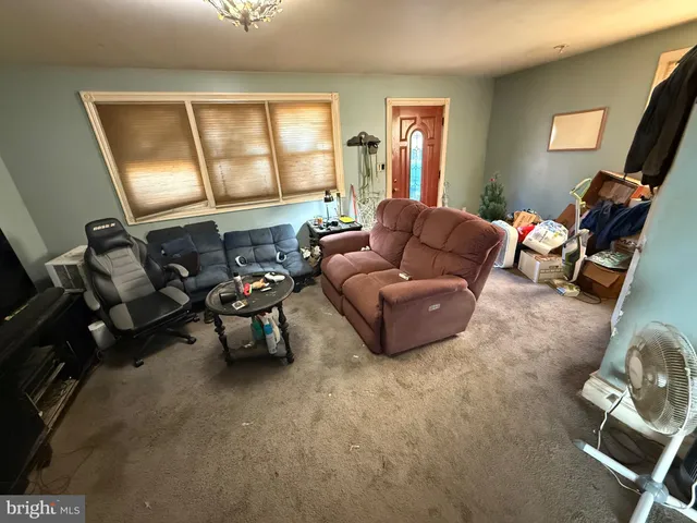 a living room with furniture and a flat screen tv with wooden floor