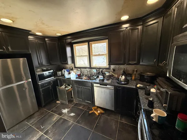 a kitchen with sink cabinets and stainless steel appliances