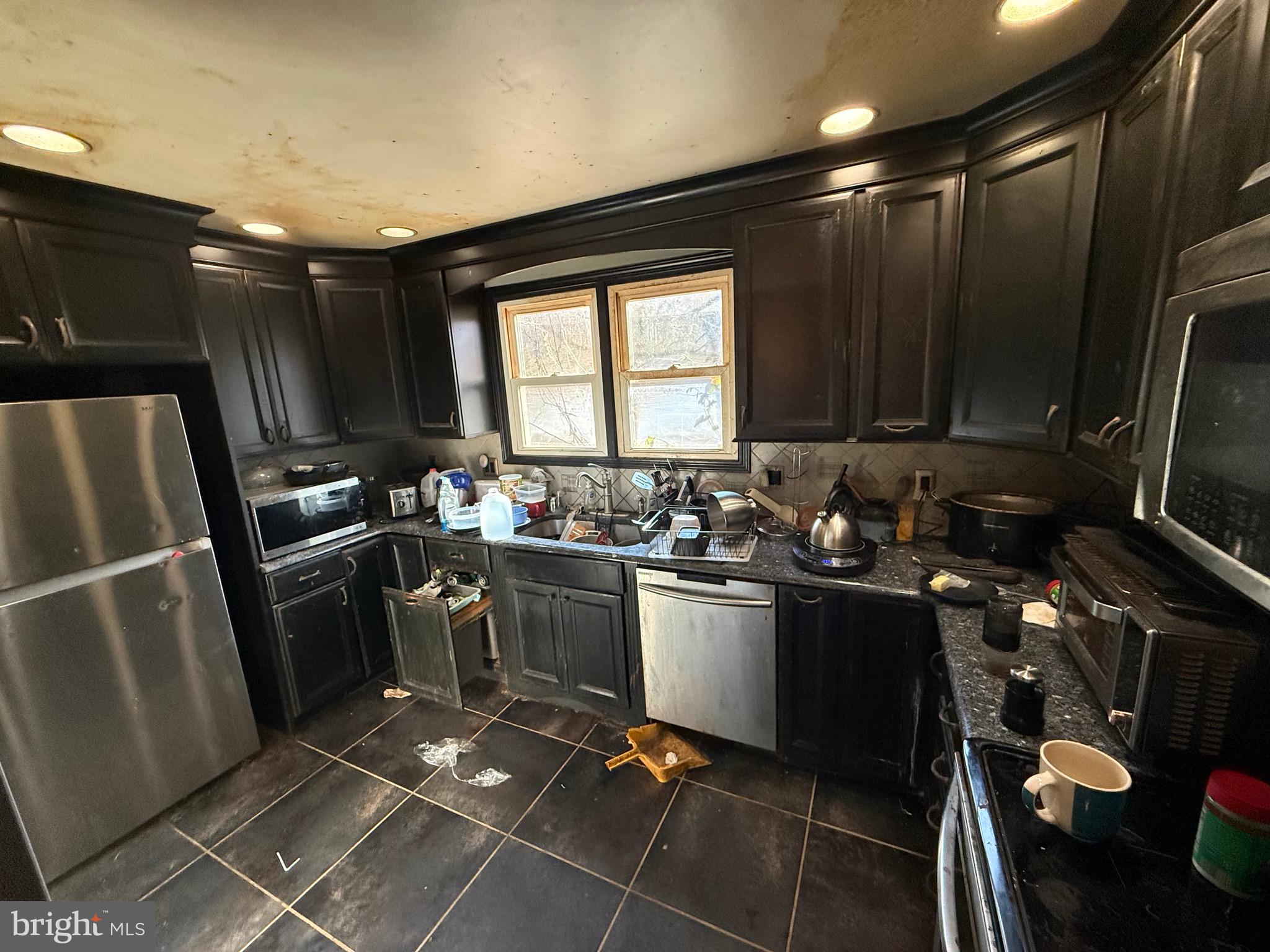 1602 Harvey Road Wilmington, DE 19810 - Photo 23 of 34 a kitchen with sink cabinets and stainless steel appliances