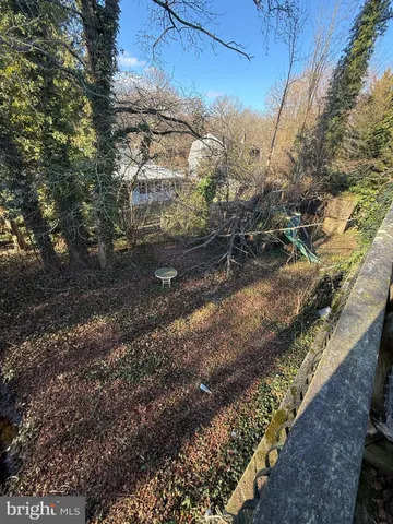 a view of a yard with wooden fence