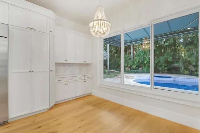 a kitchen with stainless steel appliances granite countertop a sink a stove and a refrigerator