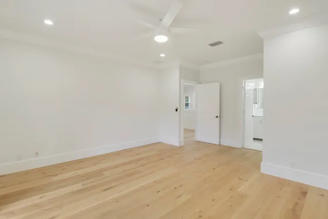 a bathroom with a toilet sink vanity and mirror