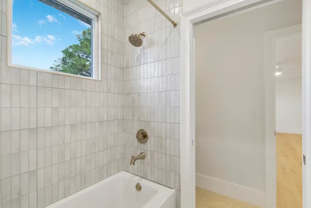 a bathroom with a bathtub and shower