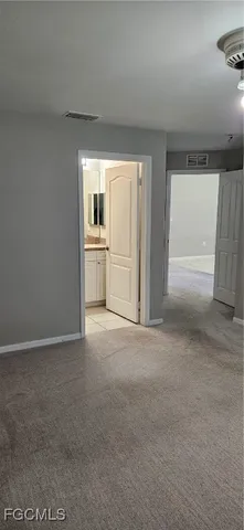a view of empty room with a fireplace and window