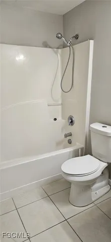 a bathroom with a toilet a sink and shower
