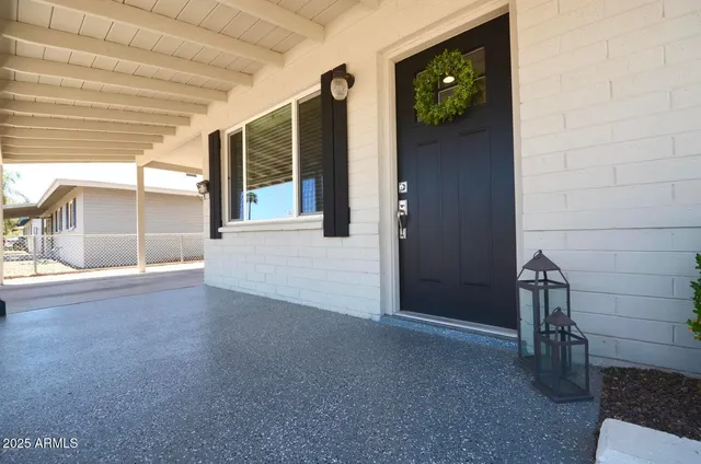 a view of an entryway with a table and chairs