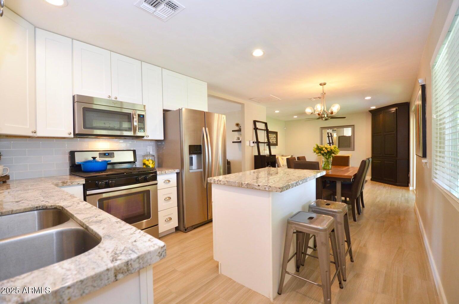 816 East Seldon Lane Phoenix, AZ 85020 - Photo 5 of 24 a kitchen with refrigerator and cabinets
