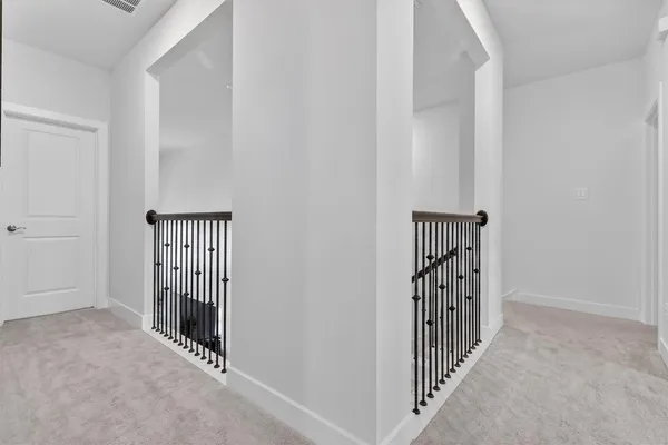 a bedroom with a bed and painting on the wall