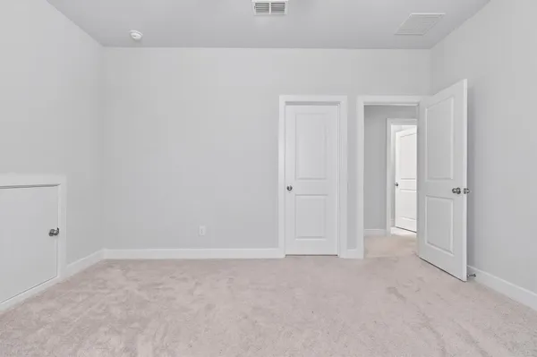 a view of a hallway with a bed
