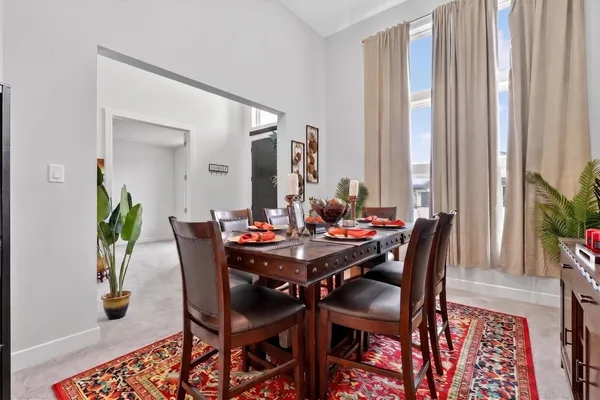 a view of a dining room with furniture and window