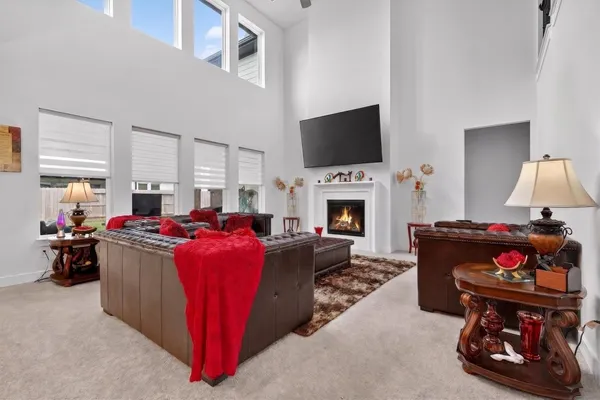 a living room with fireplace furniture and a flat screen tv