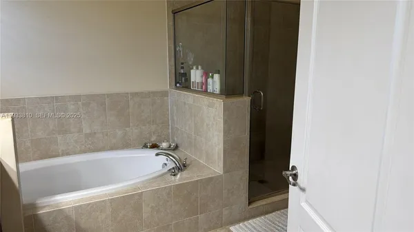 a bath tub sitting next to a shower