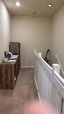 a hallway with a white cabinets