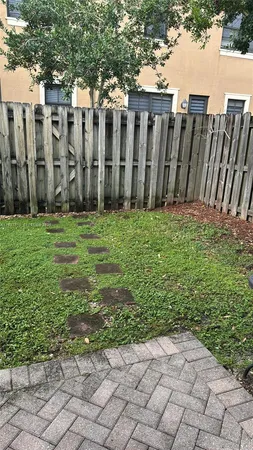 a view of a backyard with wooden fence