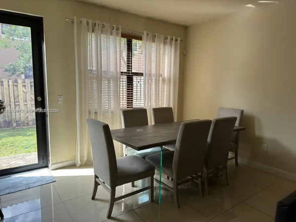 a view of a dining room with furniture and windows