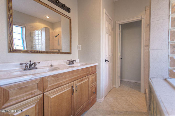 430 Churea Lane Rio Rico, AZ 85648 - Photo 12 of 14 a bathroom with a granite countertop sink mirror and double