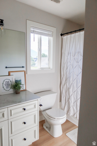 1204 North 3020th Street West Provo, UT 84601 - Photo 33 of 35 Upstairs Bathroom vanity with white cabinetry and black hardware, and wood-finish flooring