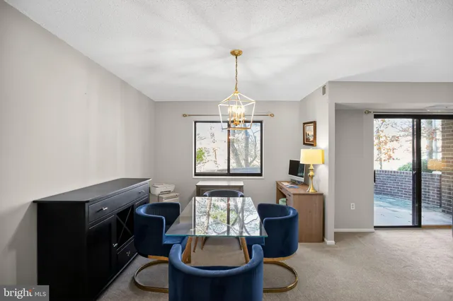 a living room with furniture a window and a chandelier