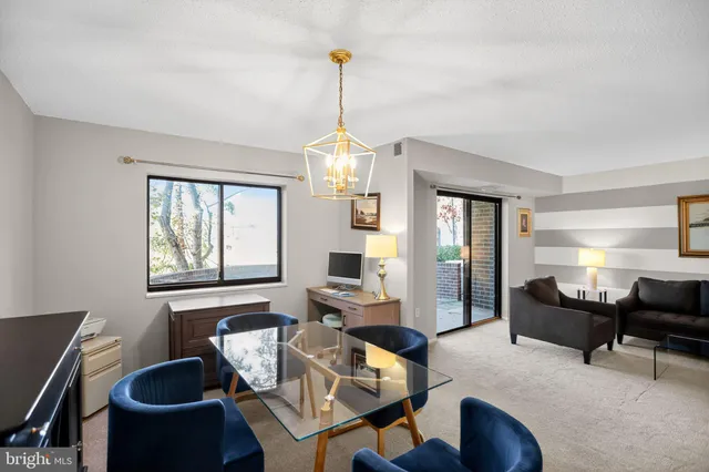 a living room with furniture a window and a chandelier
