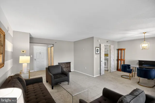 a living room with furniture and a lamp