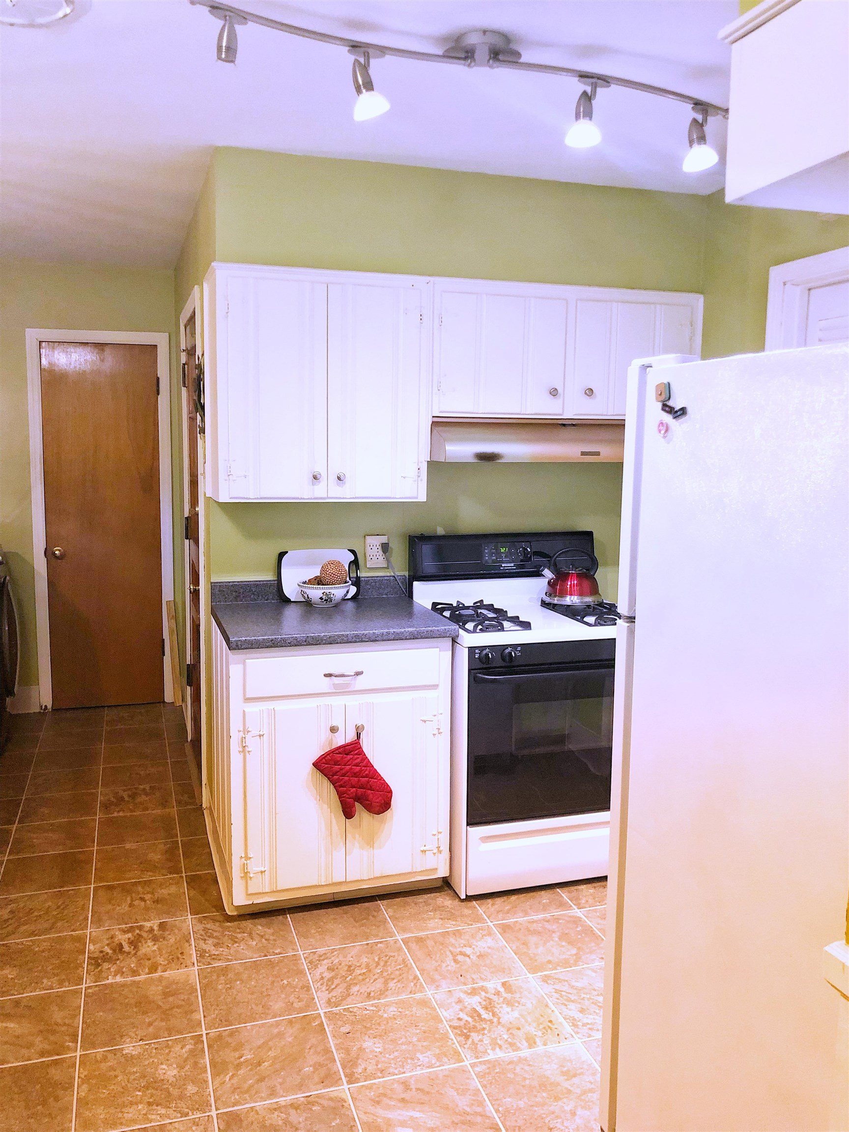 1629 Rabb Road Memphis, TN 38119 - Photo 17 of 21 a kitchen with kitchen island a stove top oven a sink and a refrigerator