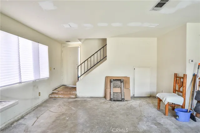 a kitchen with stainless steel appliances kitchen island granite countertop a refrigerator and a sink