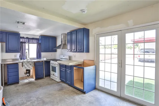 a kitchen with stainless steel appliances a stove a sink and a microwave
