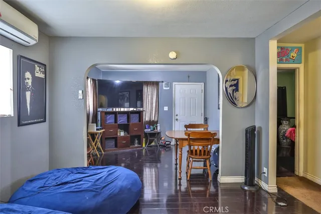 a living room with furniture a rug and a clock