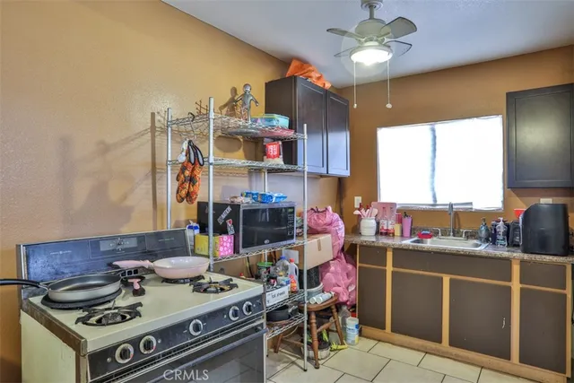 a kitchen with a stove a sink and a dining table