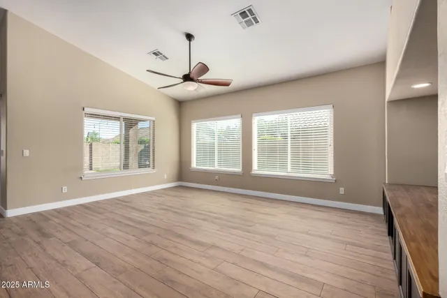 a kitchen with stainless steel appliances granite countertop a stove a sink dishwasher and a refrigerator with wooden floor