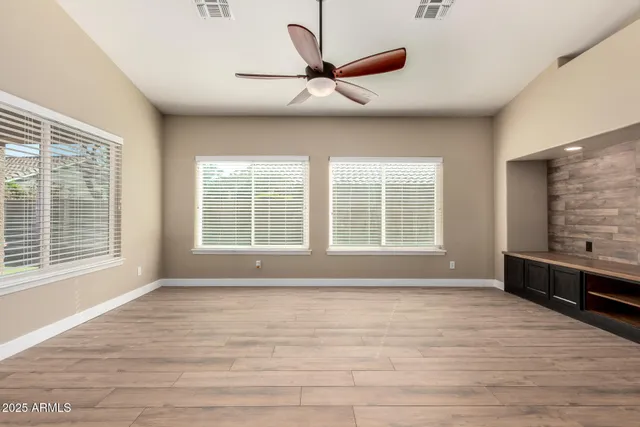 a kitchen with stainless steel appliances granite countertop a refrigerator oven a sink dishwasher and wooden cabinets with wooden floor