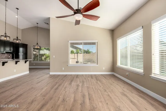 a kitchen with stainless steel appliances granite countertop a sink a stove a refrigerator and a center island