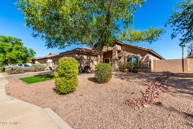 a view of a room with wooden floor table and chairs