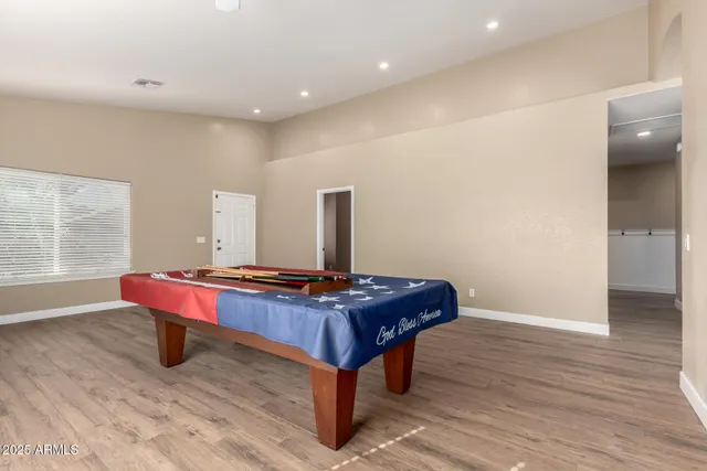 a view of empty room with wooden floor and windows