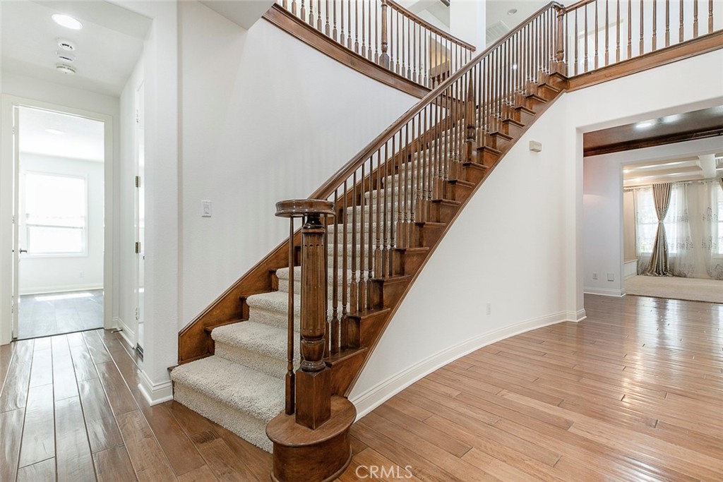 a view of entryway and hall with wooden floor
