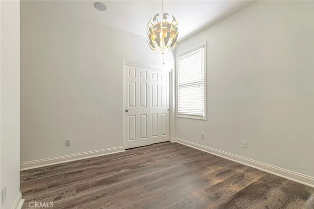 an empty room with a bathroom and a window