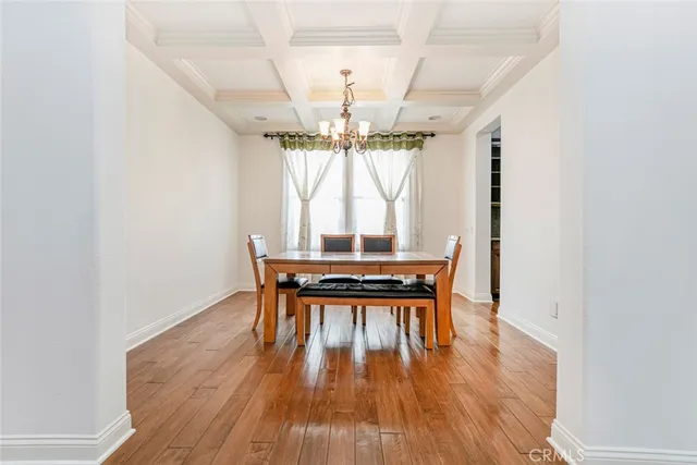 a kitchen with granite countertop wooden cabinets a sink and dishwasher with wooden floor