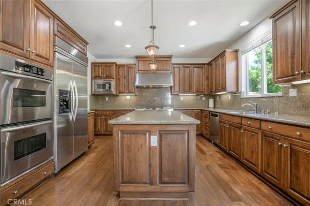 an empty room with wooden floor and a fireplace