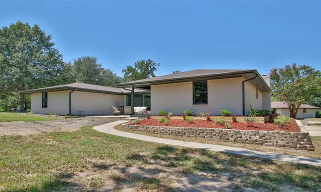 a backyard of a house with table and chairs
