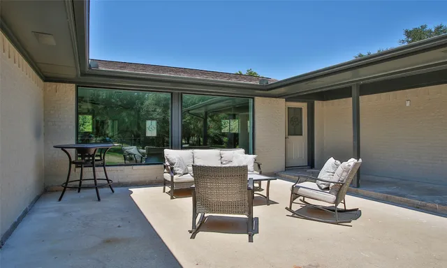a view of a patio with a table and chairs