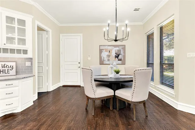 a view of a dining room with furniture wooden floor and chandelier
