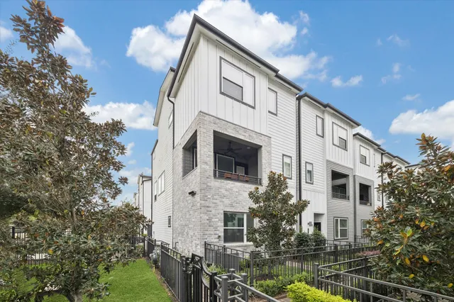 a front view of a house with plants