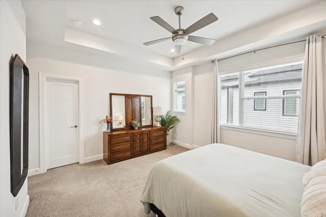 a bedroom with a large bed and a chandelier