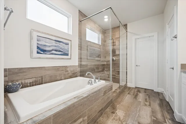 a bathroom with a bathtub and a shower